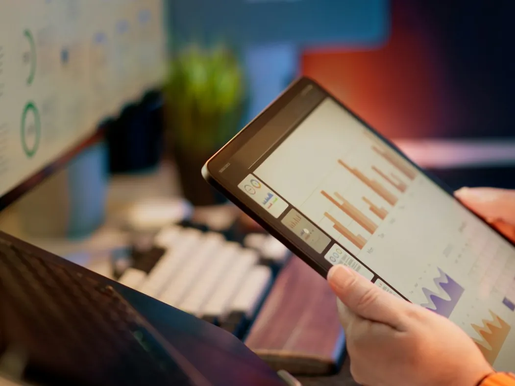 Financial reports and charts on a tablet