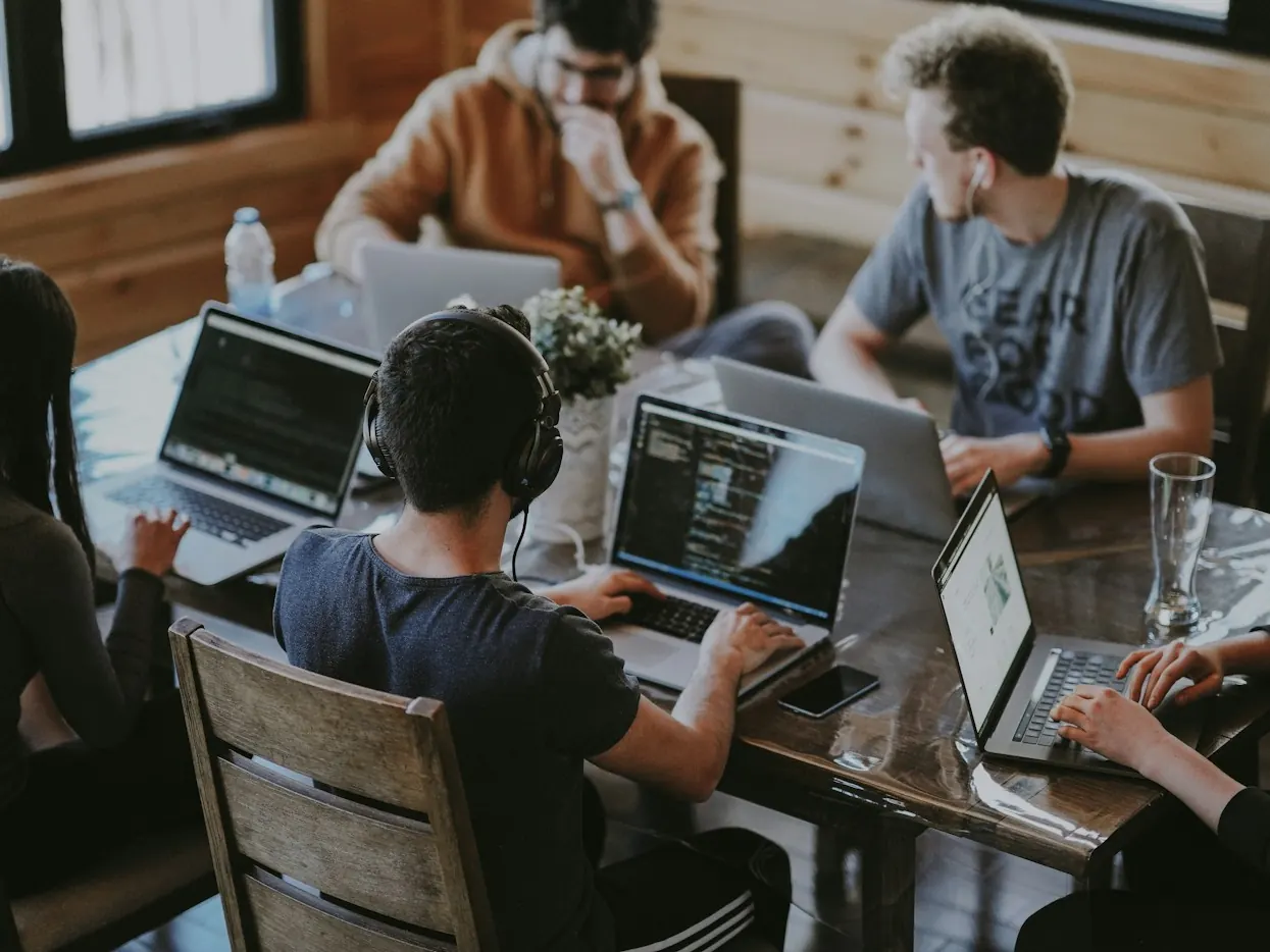 A software team working together on laptops